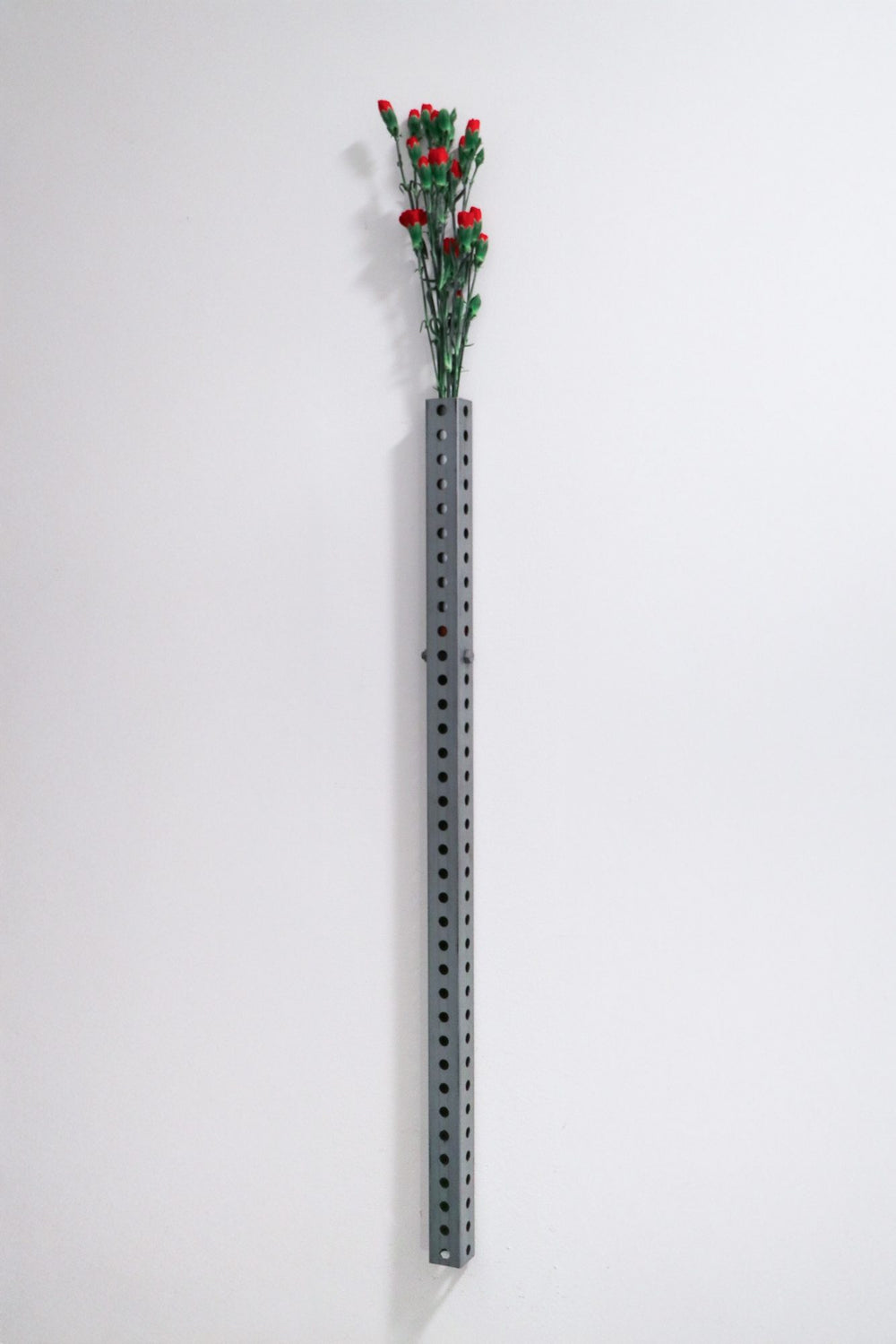 Perforated wall vase