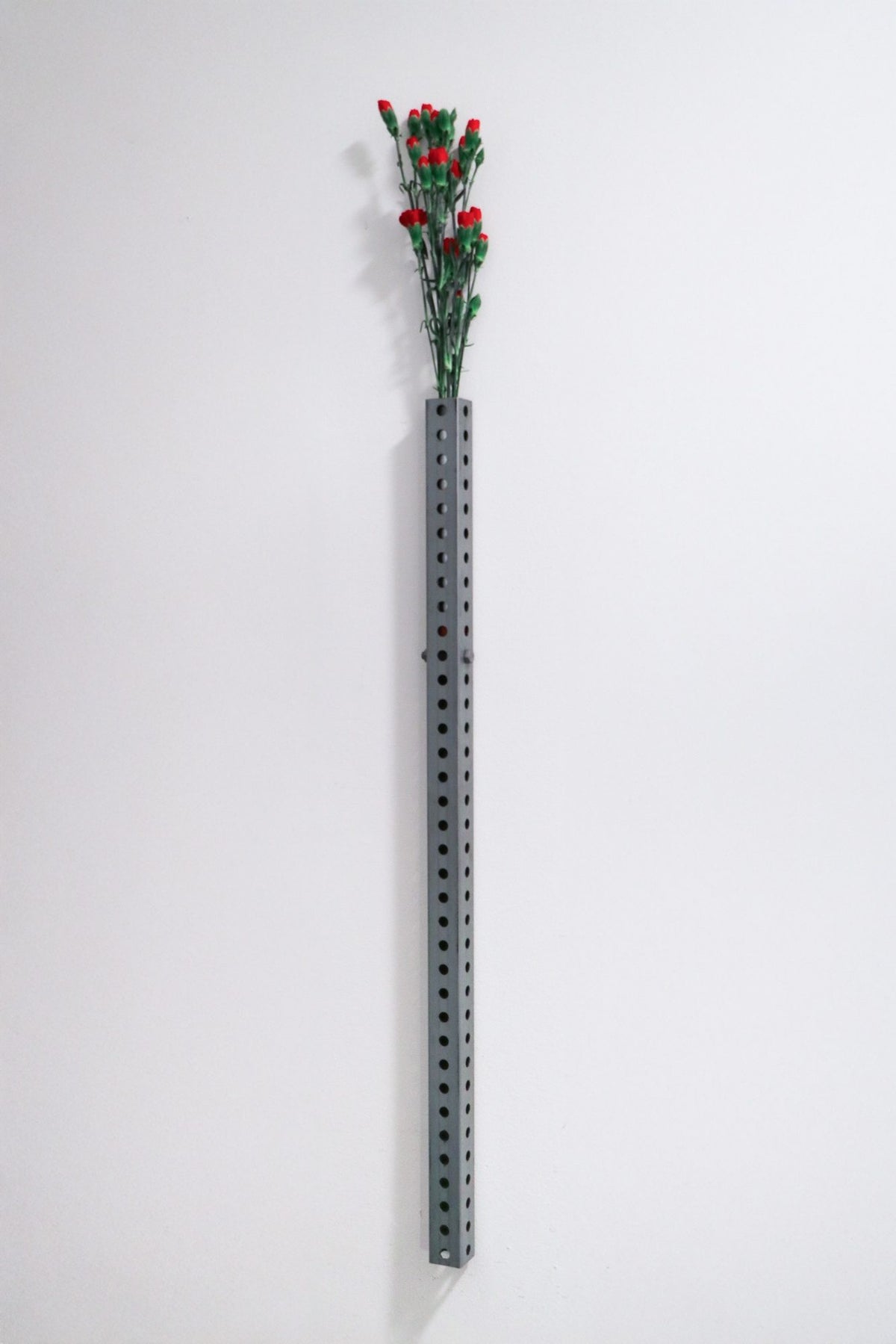 Perforated wall vase