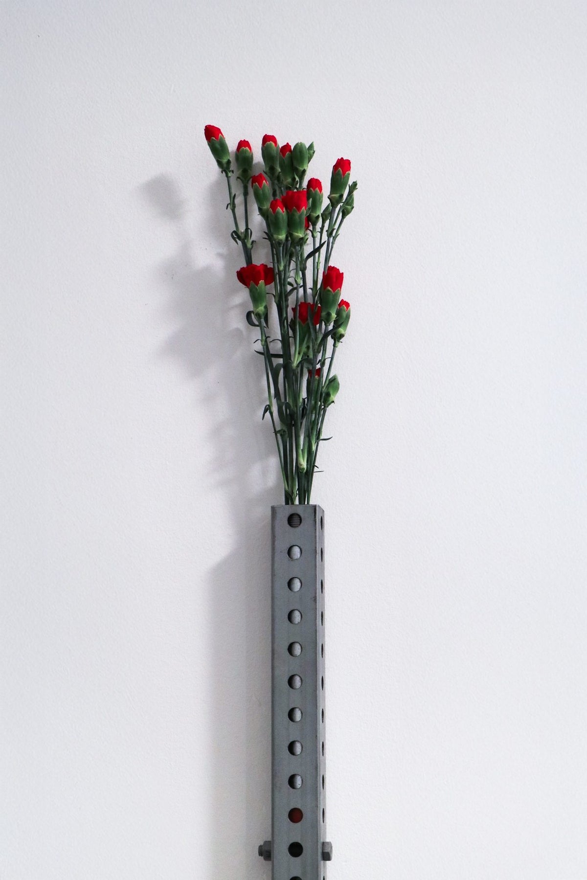 Perforated wall vase