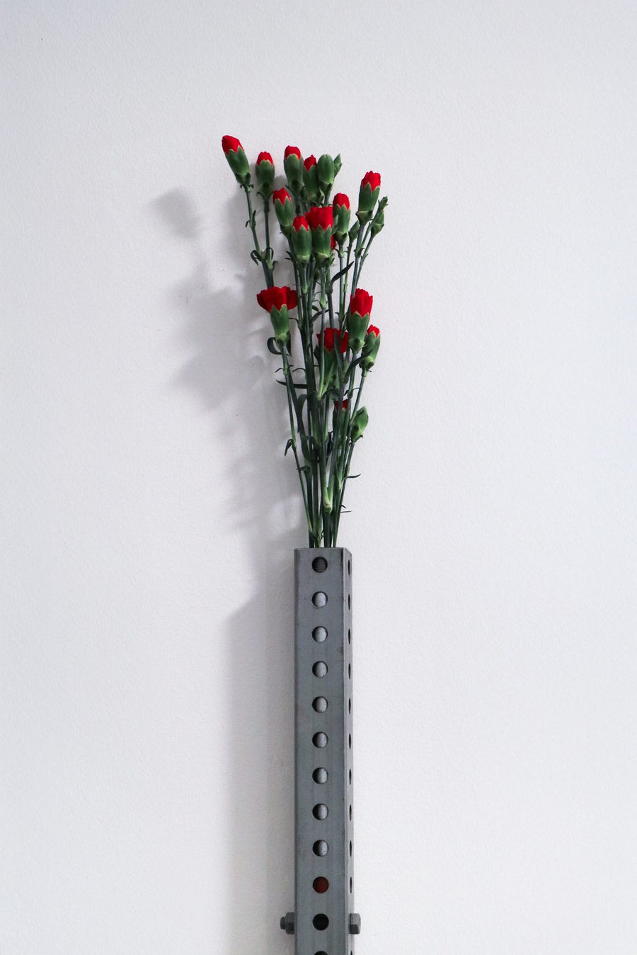 Perforated wall vase